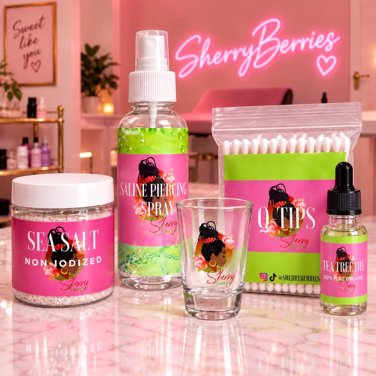 The SherryBerries aftercare kit: non-iodized sea salt, saline piercing spray, Q-tips, tea tree oil and a reusable shot glass